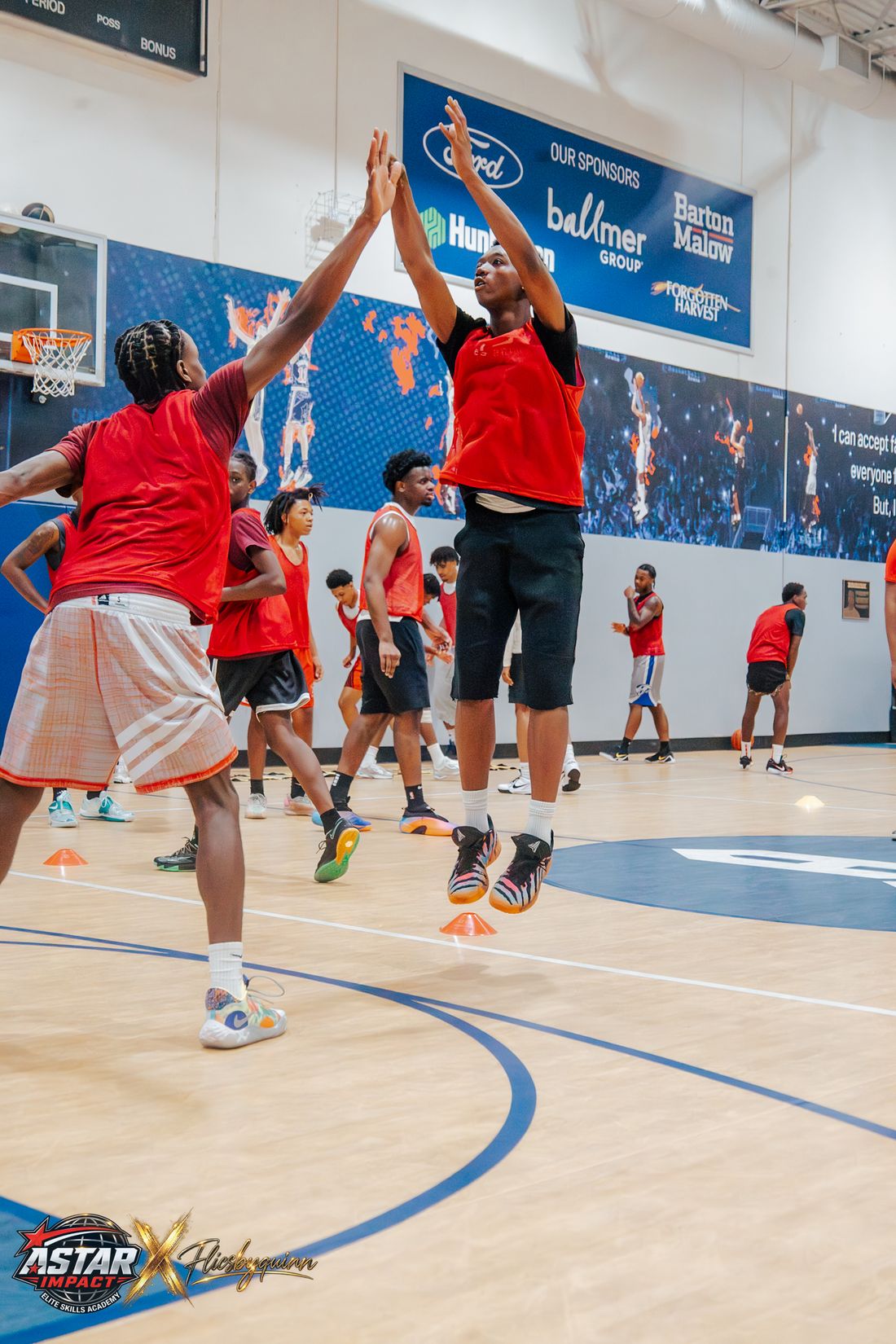 Two athletes leaping for a high five