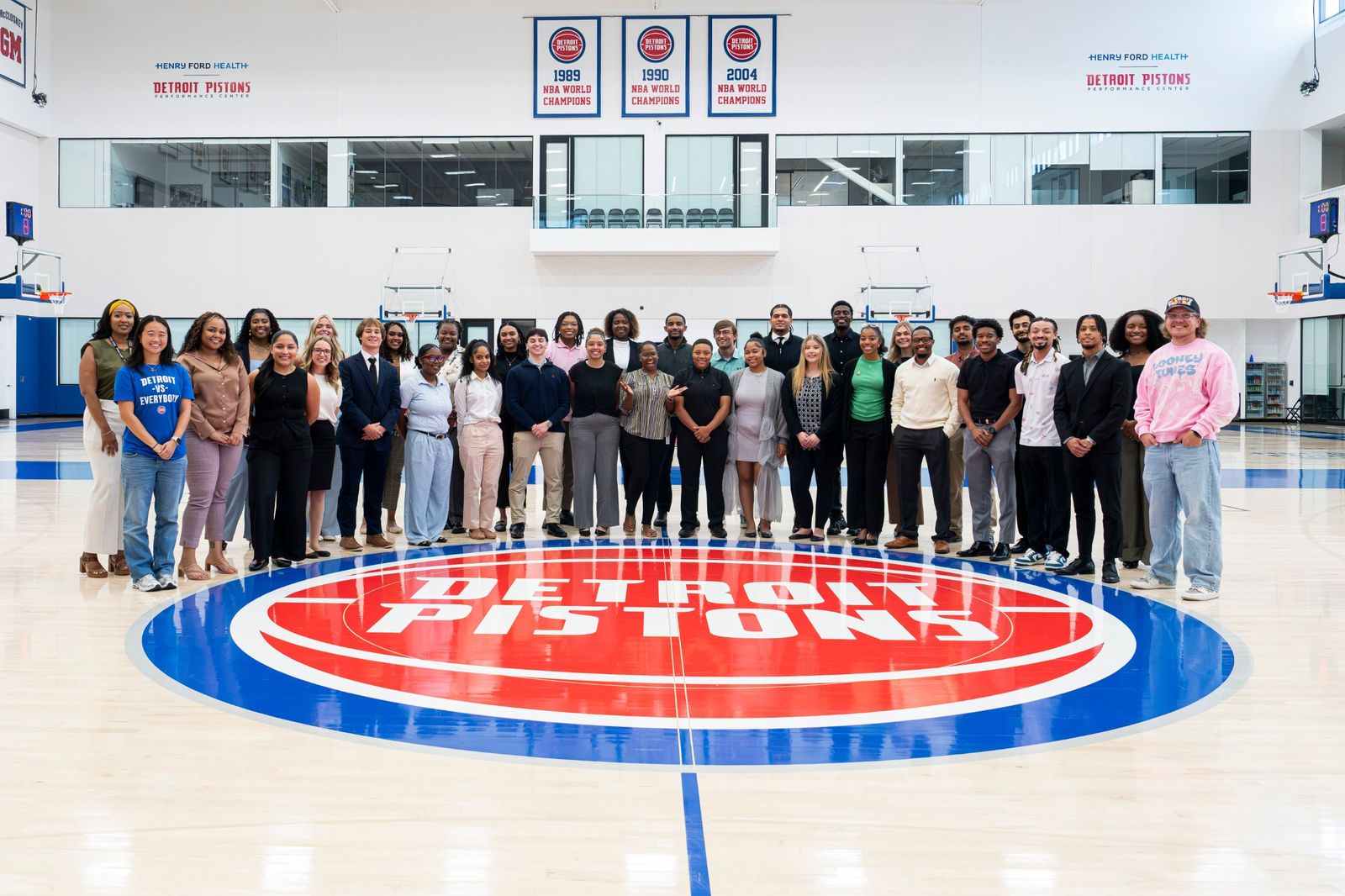 ASTAR community members at a Detroit Pistons career event, standing on the court